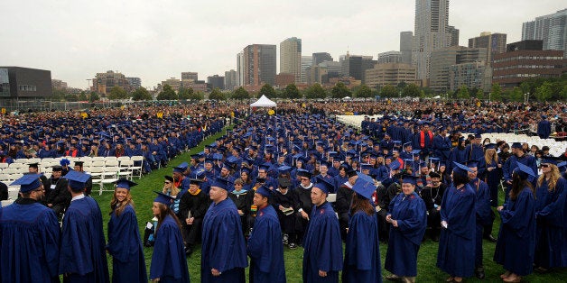 Graduates line up to receive their diplomas under cool and cloudy skies with the skyline of Denver as their backdrop. Metropolitan State College of Denver held it's Spring 2012 graduation ceremony today May 13, 2012. The commencement exercises were held on the Auraria Athletic Fields on the school's campus. President Stephen Jordan was the keynote speaker and more than 1,800 bachelor's and 60 master's students graduated at the ceremony. Metro State continues a four-year graduate growth trend with its largest-ever spring graduating class: 1,820 bachelor's candidates, exceeding last year's record of 1,484 spring graduates. Helen H. Richardson, The Denver Post (Photo By Helen H. Richardson/The Denver Post via Getty Images)