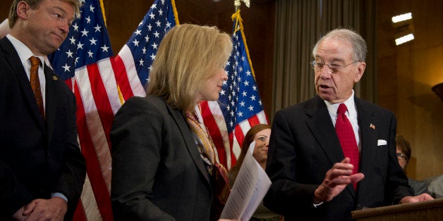 UNITED STATES - Nov 19: Sen. Dean Heller, R-NV., Sen. Kirsten Gillibrand, D-NY., and Sen. Charles Grassley, R-IA., during a press conference on Military Justice Improvement Act in Dirksen Senate Office Building on November 19, 2013. (Photo By Douglas Graham/CQ Roll Call)