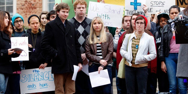 University of North Carolina-Chapel Hill sophomore Landen Gambill, center, stands with supporters during a rally Friday, March 1, 2013, on the steps of the South Building on campus in Chapel Hill, North Carolina. Gambill was informed last week by the student-run judicial system that she has been charged with an honor code violation for speaking out about alleged abuse and sexual violence by an ex-boyfriend, who also is a student on campus. (Travis Long/Raleigh News & Observer/MCT via Getty Images)