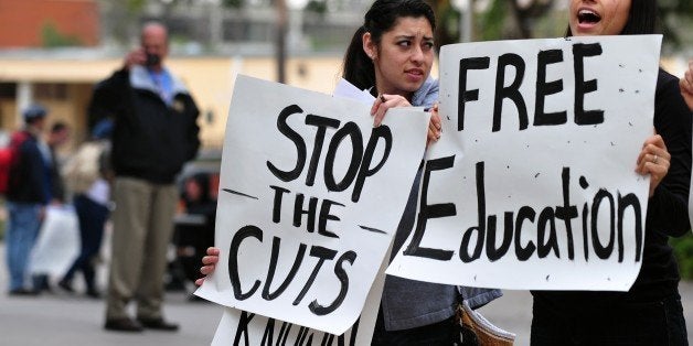 Students shout slogans while holding placards during a protest at the California State University of Los Angeles campus on Ma