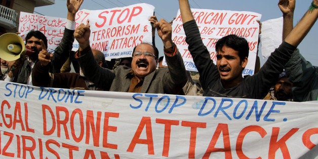 Activists from the Muttahida Shehri Mahaz shout slogans as they protest against a US drone attack in Multan on December 26, 2103. A US drone strike targeting a militant compound killed at least three suspected insurgents in a restive Pakistani tribal region near the Afghan border late December 25, officials said. AFP PHOTO/S S MIRZA (Photo credit should read S S MIRZA/AFP/Getty Images)