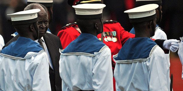 Kenya's outgoing President Mwai Kibaki (2nd L) carries out his final honor guard inspection as head of state on April 09, 2013 before a swearing in and power handover ceremony for Kenya's fourth President Uhuru Kenyatta and his Vice President William Ruto in Nairobi. Kenyatta was sworn in to thunderous cheers despite facing trial on charges of crimes against humanity. Ruto, who like Kenyatta faces trial at the International Criminal Court (ICC) for crimes against humanity related to post-election violence five years ago when more than 1,100 people were killed, took the oath as vice president. AFP PHOTO / TONY KARUMBA (Photo credit should read TONY KARUMBA/AFP/Getty Images)