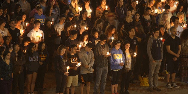 LOS ANGELES , CA - MAY 26: Students of UCSB and UCLA mourn at a candlelight vigil at UCLA for the victims of a killing rampage over the weekend near UCSB on May 26, 2014 in Los Angeles, California. According to reports, 22 year old Elliot Rodger, son of assistant director of the Hunger Games, Peter Rodger, began his mass killing near the University of California, Santa Barbara by stabbing three people to death in an apartment. He then went on to shooting and running down people while driving his BMW until crashing with a self-inflicted gunshot wound to the head. Officers found three legally-purchased guns registered to him inside the vehicle. Prior to the murders, Rodger posted YouTube videos declaring his intention to annihilate the girls who rejected him sexually and others in retaliation for his remaining a virgin at age 22. Seven people died, including Rodger, and seven others were wounded. (Photo by David McNew/Getty Images)