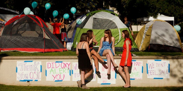 Carly Mee, a student at Occidental College, center, talks with other students during the Oxy Sexual Assault Coalition (OSAC) sexual assault awareness night campout at the college campus in Los Angeles, California, U.S., on Friday, April 19, 2013. A group of Occidental students and alumni filed a Title IX complaint with the Education Department on April 18 saying the school doesnt meet federal standards for preventing and responding to rapes and other sexual assaults on campus. Photographer: Patrick Fallon/Bloomberg via Getty Images 