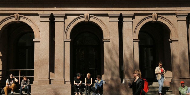 NEW YORK, NY - APRIL 24: Students sit in front of Cooper Union for the Advancement of Science and Art, one of the last tuition-free colleges in the country, on April 24, 2013 in New York City. Cooper Union recently announced that for the first time in more than a century it will begin charging undergraduates to attend the school starting in the fall of 2014. While the school will not charge students in severe financial hardship, those that can will pay around $20,000 per year. (Photo by Spencer Platt/Getty Images)