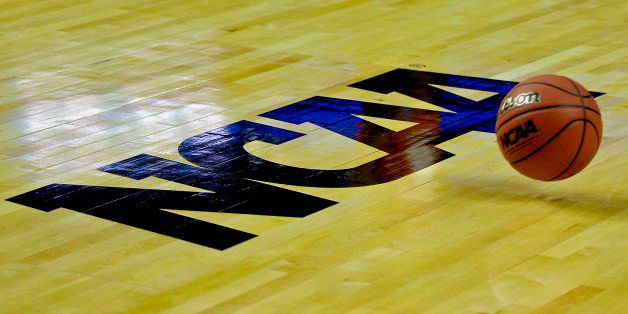 A ball bounces past the logo during NCAA college basketball practice in Buffalo, N.Y. on Thursday, Mar. 18, 2010. (AP Photo/Don Heupel)
