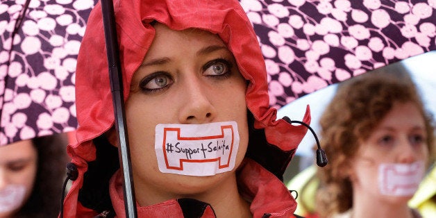 Students tape their mouths shut in support for Steve Salaita, a professor who lost a job offer from the University of Illinois over dozens of profane Twitter messages that critics deemed anti-Semitic, during a rally at the University of Illinois campus Tuesday, Sept. 9, 2014, in Champaign Ill. (AP Photo/Seth Perlman)