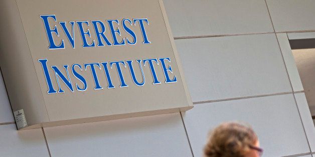 A person walks past an Everest Institute sign in a office building in Silver Spring, Md., Tuesday, July 8, 2014. The dozen campuses that for-profit education company Corinthian Colleges Inc. is closing operate under the Everest name and are scattered in 11 different states, the company announced. (AP Photo/Jose Luis Magana)