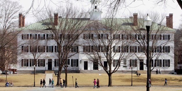 In this photo taken Monday March 12, 2012, students walk across the Dartmouth College campus green in Hanover, N.H. More than a quarter of the Sigma Alpha Epsilon fraternity's membership has been accused by the school's judicial council of hazing after a former member's public airing of what he says he experienced as a pledge in 2009, including being forced to swim in a kiddie pool of vomit and other bodily fluids. (AP Photo/Jim Cole)