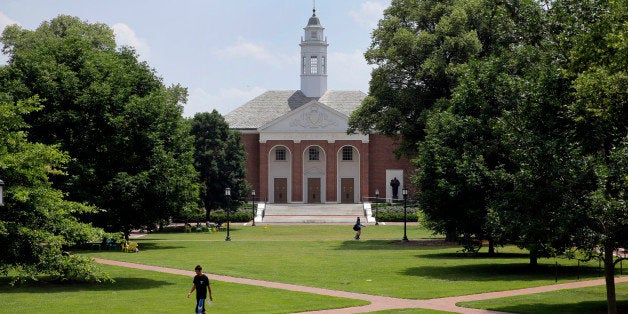 In this July 8, 2014 picture, people walk on Johns Hopkins University's Homewood campus in Baltimore. Johns Hopkins is under investigation for its handling of an alleged gang rape of a Towson University student at a fraternity house, Pi Kappa Alpha, in the spring of 2013. Since the allegation became public in May, Hopkins students have come out of the woodwork to share their own sexual assault stories, said Laura Dunn, an advocate with nonprofit organization SurvJustice who helped file the initial complaint. (AP Photo/Patrick Semansky)