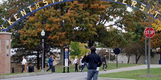 Students walk the campus at Kent State University in Kent, Ohio Wednesday, Oct. 15, 2014. Students and staff at the were notified that three employees of the university are related to the nurse in Dallas who exhibited Ebola symptoms and had contact with her over the weekend. The three have been asked to remain off campus for three weeks as a precaution. (AP Photo/Mark Duncan)