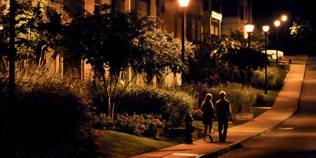 CHARLOTTESVILLE, VA- SEPTEMBER 19: A couple walks on the sidewalk after 2am at the apartment complex where Hannah Graham lived in Charlottesville. Photos depict the route (as captured by surveillance cameras) thought to be where the lasting sightings of Hannah Graham occurred. Images were made in the early a.m. hours after midnight to approximate the conditions under which she was last seen. She went missing in downtown last Saturday morning. (Photo by Michael S. Williamson/The Washington Post via Getty Images)