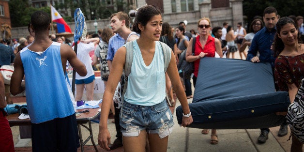 NEW YORK, NY - SEPTEMBER 05: Emma Sulkowicz, a senior visual arts student at Columbia University, carries a mattress, with the help of three strangers who met her moments before, in protest of the university's lack of action after she reported being raped during her sophomore year on September 5, 2014 in New York City. Sulkowicz has said she is committed to carrying the mattress everywhere she goes until the university expels the rapist or he leaves. The protest is also doubling as her senior thesis project. (Photo by Andrew Burton/Getty Images)