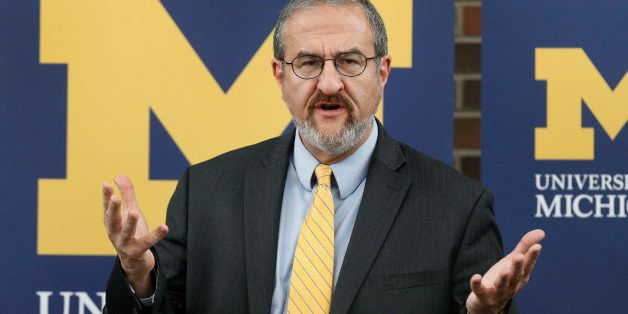 University of Michigan President Mark Schlissel announces that athletic director Dave Brandon resigned during a news conference in Ann Arbor, Mich., Friday, Oct. 31, 2014. Former Steelcase CEO Jim Hackett will serve as Michigan's interim athletic director. (AP Photo/Paul Sancya)