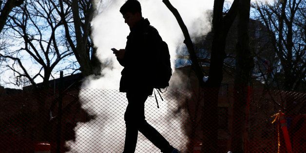 A student walks past vented steam in freezing temperatures on the University of Pennsylvania campus, Tuesday, March 4, 2014, in Philadelphia. A blast of arctic air sent temperatures plummeting into the single digits Tuesday. (AP Photo/Matt Rourke)