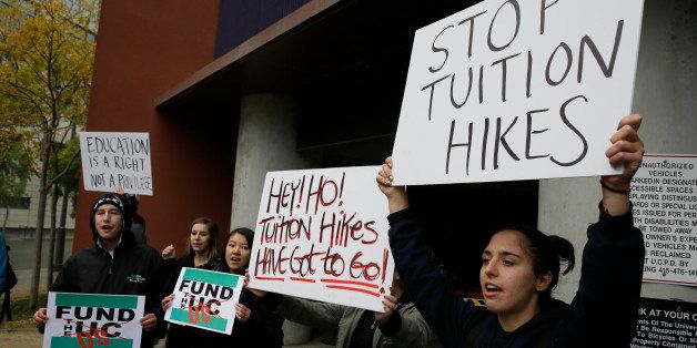 Student protesters block the entrance to a parking garage outside a meeting of the University of California Board of Regents Wednesday, Nov. 19, 2014, in San Francisco. A committee of the Regents approved Janet Napolitano's proposal to raise tuition by 5 percent in each of the next five years unless the system gets more money from Sacramento.(AP Photo/Eric Risberg)