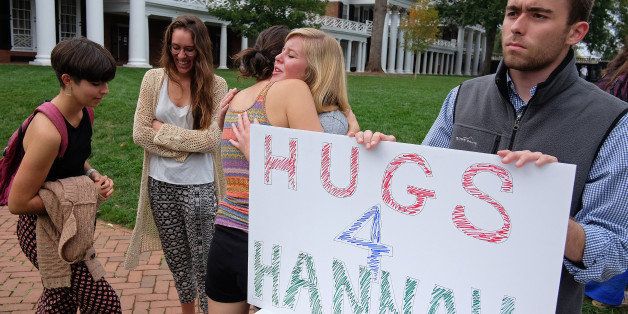 Charlottesville, VA - October 3: Amalia Harte (center back to camera) a sophomore from Herndon, Va. hugs Samantha Westrum, a sophomore from Orange County, Ca. at Hugs for Hannah, an event sponsored by the Society for Awakening Souls held on the lawn at the University of Virginia, Friday October 3, 2014. At right, Patrick Rice, a sophomore from Franklin Lakes, N.J. holds the Hugs for Hannah sign. Hannah Graham has been missing since the morning of September 13, 2014. (Photo by Norm Shafer/ For The Washington Post via Getty Images).