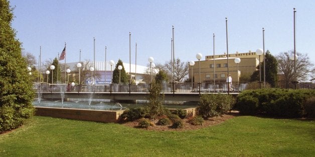 People cross over the walkway near the fountains on the campus of Bob Jones University in Greenville, S.C. Wednesday, March