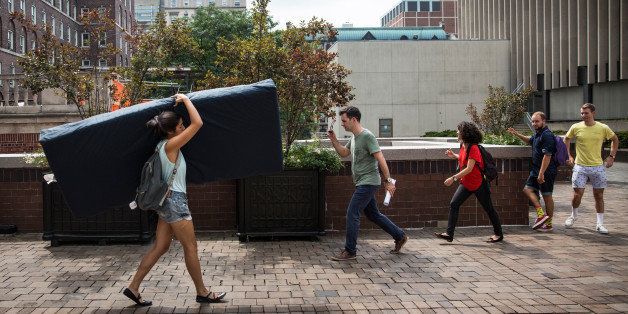 NEW YORK, NY - SEPTEMBER 05: Emma Sulkowicz, a senior visual arts student at Columbia University, carries a mattress in protest of the university's lack of action after she reported being raped during her sophomore year on September 5, 2014 in New York City. Sulkowicz has said she is committed to carrying the mattress everywhere she goes until the university expels the rapist or he leaves. The protest is also doubling as her senior thesis project. (Photo by Andrew Burton/Getty Images)