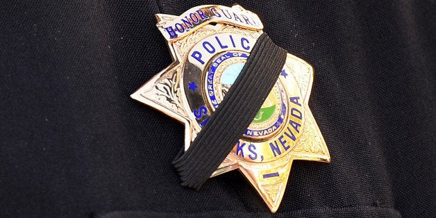 LAS VEGAS, NV - JUNE 14: Sparks Police Department Lt. and honor guard coordinator Pete Krall wears a badge with a black ribbon across it as he waits for the start of the funeral for Las Vegas Metropolitan Police Department Officer Alyn Beck at The Smith Center for the Performing Arts on June 14, 2014 in Las Vegas, Nevada. Police said Beck and Officer Igor Soldo were shot and killed on June 8 at a restaurant by Jerad Miller and his wife Amanda Miller. Police said the Millers then went into a nearby Wal-Mart where Amanda Miller killed Joseph Wilcox before police killed Jerad Miller and Amanda Miller killed herself. (Photo by Ethan Miller/Getty Images)