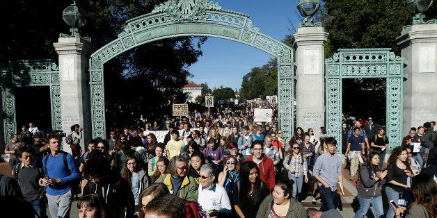 Students march under Sather Gate during a protest about tuition increases at the University of California Berkeley in Berkeley, Calif., Monday, Nov. 24, 2014. Students protesting tuition hikes in the University of California system staged walkouts at multiple campuses after the UC Board of Regents voted 14-7 to approve increases of as much as 5 percent in each of the next five years unless the state devotes more money to the system on Thursday, Nov. 20. (AP Photo/Jeff Chiu)