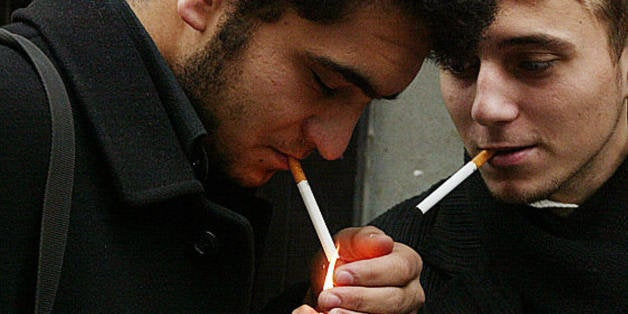 TO GO WITH AFP STORY BY Burak AKINCI - Turkish students light up their cigarettes in Istanbul, 09 January 2008. Parliament in Turkey has voted to introduce a blanket ban on smoking in enclosed public places. Banning smoking was until recently completely unthinkable in Turkey, where 40% of the adult population - 25 million people - are smokers. Smoking is such a widespread, deep-rooted and cross-cultural habit in this country that even the French and the Italians - no slouches themselves when it comes to lighting up - say of a chain-smoker that he or she 'smokes like a Turk.' AFP PHOTO/MUSTAFA OZER (Photo credit should read HOCINE ZAOURAR/AFP/Getty Images)