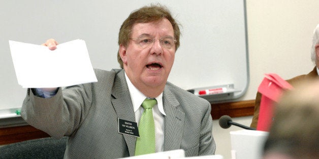 Sen. Ray Holmberg, R-Grand Forks, passes out amendments during a Senat Appropriations Committee meeting at the Capitol in Bismarck, N.D., on Thursday, April 5, 2007. The committee agreed to set aside 42 million dollars for state prison improvements. Holmberg, the committee chairman, said the action clears the way for talks with the state House on the issue. (AP Photo/Will Kincaid)