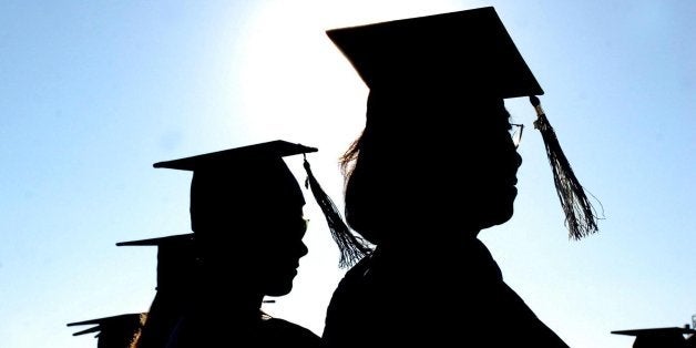 Graduation day, caps, tassels, mortarboard caps, four silhouette graduates in Mansfield, New Jersey United States