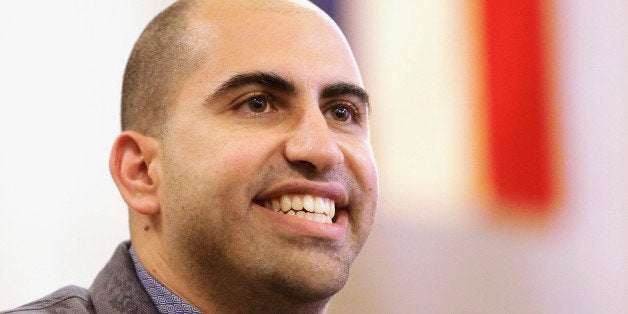FILE - In this Sept. 9, 2014 file photo, Steve Salaita, a professor who lost a job offer from the University of Illinois over dozens of profane Twitter messages that critics deemed anti-Semitic, speaks to students and reporters during a news conference at the campus in Champaign Ill. On Monday, Sept. 15, 2014, university Chancellor Phyllis Wise told a committee of faculty leaders that she regretted the uproar caused by the decision not hire Steven Salaita. She told the campus' Senate Executive Committee that university's board of trustees will be asked to consider approving the hiring of future tenured faculty much earlier in the process. (AP Photo/Seth Perlman, File)