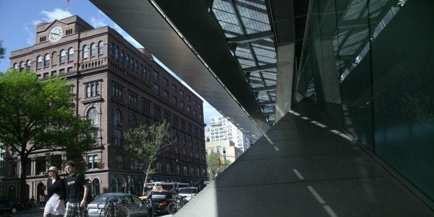 The 151-year-old Cooper Union building is framed by its modern namesake, Tuesday April 20, 2010, in New York. President Bara