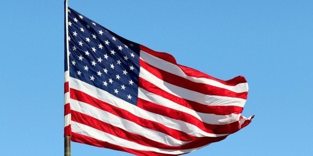 SOUTHFIELD, MI - FEBRUARY 27: An American Flag flies at the Southfield Town Center on February 27, 2015 in Southfield, Michigan. (Photo By Raymond Boyd/Getty Images)