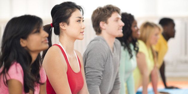 Diverse young adults doing yoga