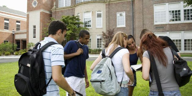 Group of students discussing outside school building