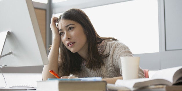 Frustrated college student studying at computer