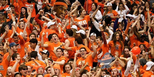 FILE - In this Feb. 1, 2014 file photo, Syracuse fans celebrate after the team defeated Duke in an NCAA college basketball ga