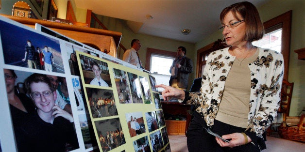 In this Dec. 9, 2011 photo, Jane Clementi looks at family photographs at her home in Ridgewood, N.J. Jane Clementi , the mother of Tyler Clementi, a Rutgers student who killed himself after his roommate allegedly used a webcam to spy on his intimate encounter with another man, says that he had a lot on his mind just before he went to college. (AP Photo/Mel Evans)