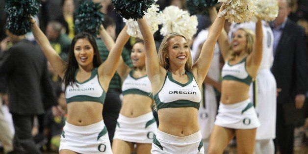 Oregon cheerleaders lead fans in a celebration as the Ducks take the lead early over the Washington State Cougars in an NCAA college basketball game in Eugene, Ore., Sunday, Feb. 8, 2015. (AP Photo/Chris Pietsch)