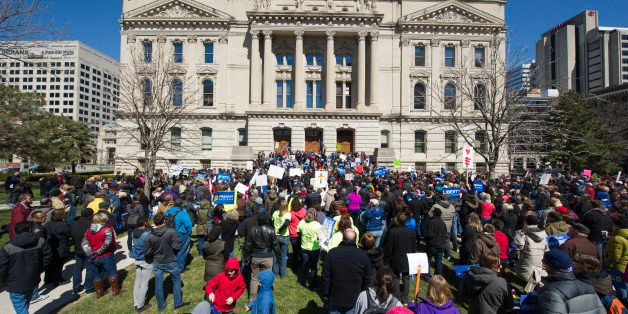 Thousands of opponents of Indiana Senate Bill 101, the Religious Freedom Restoration Act, gathered on the lawn of the Indiana State House to rally against that legislation Saturday, March 28, 2015. Indiana's law has been widely criticized by businesses and organizations around the country. (AP Photo/Doug McSchooler)