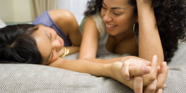 Women lying down on bed