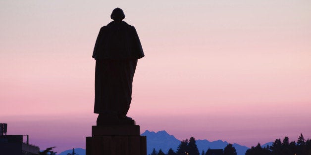'Silhouette of George Washington statue at University of Washington campus in Seattle, WA at night, sculpted by Lorado Taft (