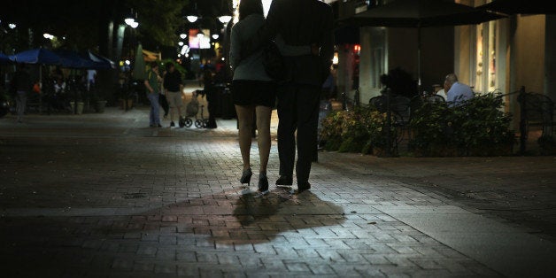 CHARLOTTESVILLE, VA - OCTOBER 02: A couple walk through the Downtown Mall October 2, 2014 in Charlottesville, Virginia. Eighteen-year-old University of Virginia sophomore Hannah Graham went missing early in the morning of September 13, 2014. It has been reported that she was last seen outside Tempo restaurant at the Downtown Mall in Charlottesville. (Photo by Alex Wong/Getty Images)