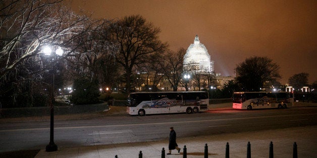 The U.S. Capitol in Washington is seen Wednesday evening, Jan. 14, 2015. A man who plotted to attack the U.S. congressional building and kill government officials inside it and spoke of his desire to support the Islamic State group was arrested on Wednesday, the FBI said. The Capitol Dome is covered with scaffolding for a long-term repair project. (AP Photo/J. Scott Applewhite)