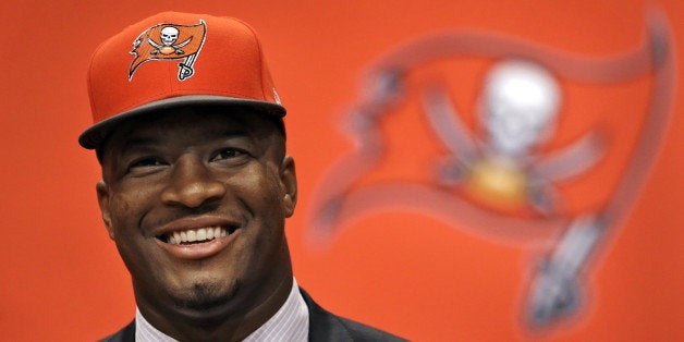 Former Florida State quarterback Jameis Winston, selected as the No.1 overall pick in the NFL draft by the Tampa Bay Buccaneers, smiles during a news conference Friday, May 1, 2015, in Tampa, Fla. (AP Photo/Chris O'Meara)