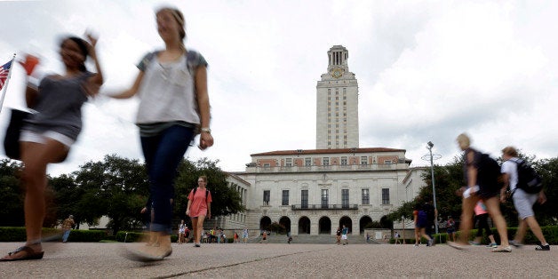 FILE - In this Sept. 27, 2012 file photo, students walk through the University of Texas at Austin campus near the school's iconic tower in Austin, Texas. The cost of funding higher education for veterans has increased sevenfold since Texas legislators allowed veterans to pass the benefit onto a child. (AP Photo/Eric Gay, File)