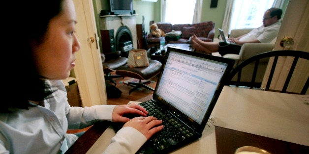 **FOR USE WITH AP LIFESTYLES** Tina Lee Naro, left, uses her computer as her husband Alex Naro, background, works on his computer at their home in New York, Friday, May 2, 2008. Ten years after graduating from Taylor High School in Katy, Texas, Tina Lee Naro learned some surprising things about her former classmates by viewing their pages on the online social networking site Facebook. (AP Photo/Bebeto Matthews)