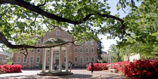 In this photo taken Monday, April 20, 2015 people take pictures at the Old Well on campus at The University of North Carolina