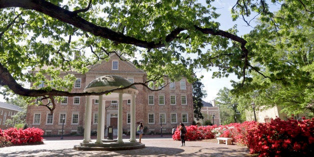 In this photo taken Monday, April 20, 2015 people take pictures at the Old Well on campus at The University of North Carolina in Chapel Hill, N.C. (AP Photo/Gerry Broome)