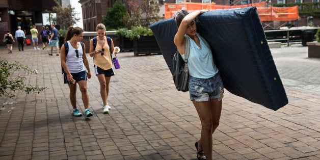 NEW YORK, NY - SEPTEMBER 05: Emma Sulkowicz, a senior visual arts student at Columbia University, carries a mattress in protest of the university's lack of action after she reported being raped during her sophomore year on September 5, 2014 in New York City. Sulkowicz has said she is committed to carrying the mattress everywhere she goes until the university expels the rapist or he leaves. The protest is also doubling as her senior thesis project. (Photo by Andrew Burton/Getty Images)