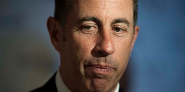 Jerry Seinfeld pauses as he is interviewed on the red carpet at the Kennedy Center for the Performing Arts for the Mark Twain Prize for American Humor on Sunday, Oct. 19, 2014, in Washington. (AP Photo/Kevin Wolf)