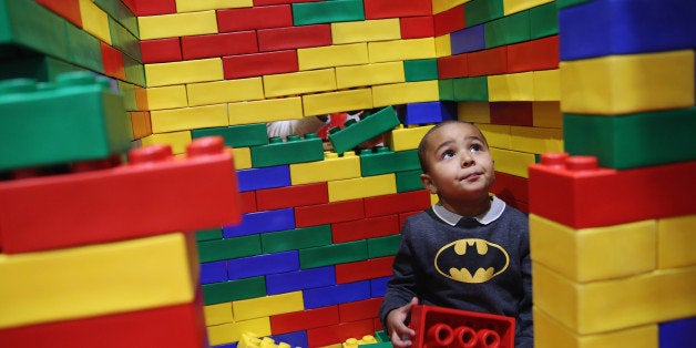 LONDON, ENGLAND - NOVEMBER 27: Marli Williams, 9, plays in a Lego building area on the opening day of BRICK 2014 at the Excel Centre on November 27, 2014 in London, England. The four day event showcases creations by some of the world's best Lego builders and runs until November 30th. (Photo by Dan Kitwood/Getty Images)